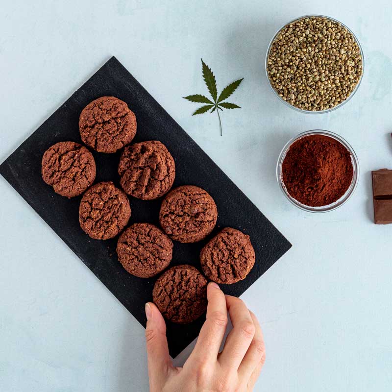 cannabis dosing (hand reaching for cannabis cookie)